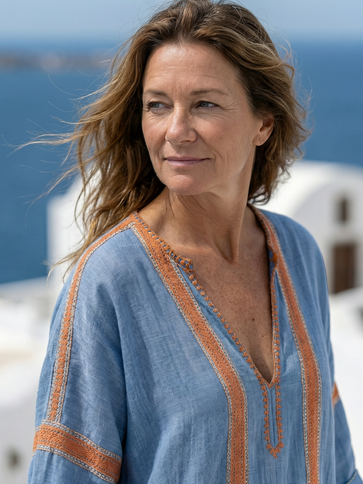 Relaxed fit blue V-neck midi dress for women. Comfortable short-sleeve summer, casual, and travel fashion.