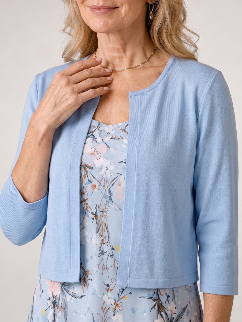Vibrant floral print sleeveless midi dress paired with a stylish cropped jacket for women. Summer outfit.