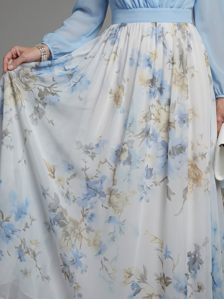 Flowing women's summer floral maxi dress, features V-neck, sheer top, and elegant design for warm evenings.