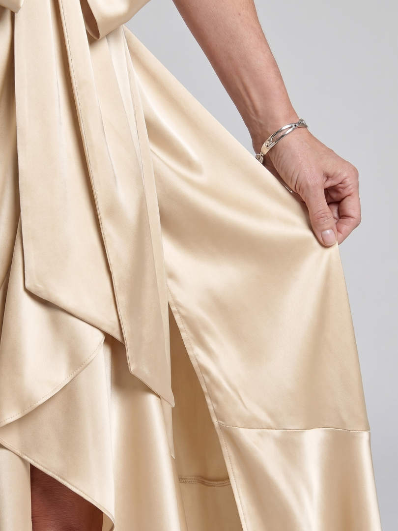 Flowy sleeveless women's halter wrap midi dress, featuring a flattering asymmetric hem. Great for parties.