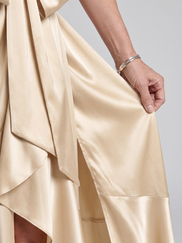 Flowy sleeveless women's halter wrap midi dress, featuring a flattering asymmetric hem. Great for parties.