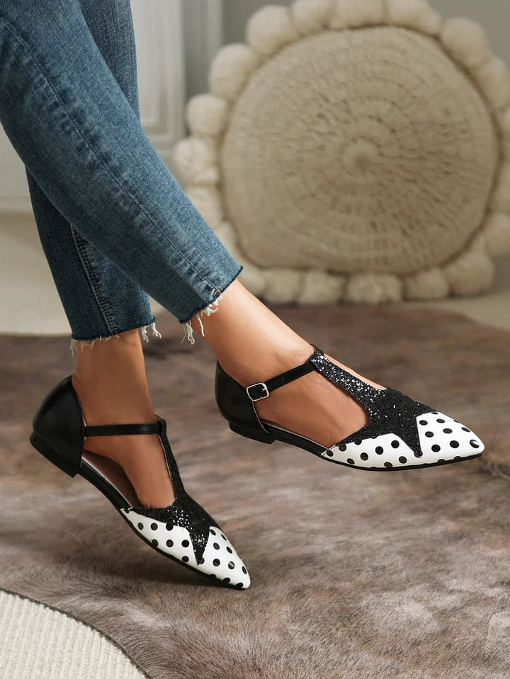 Elegant women's polka dot T-bar ballet flats. These comfortable patterned shoes offer versatile style for any occasion.