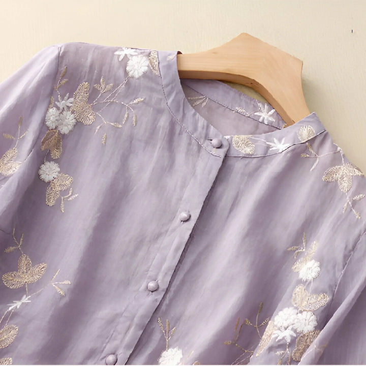 Flattering women's top with elegant floral embroidery and a comfortable tummy skimming fit.