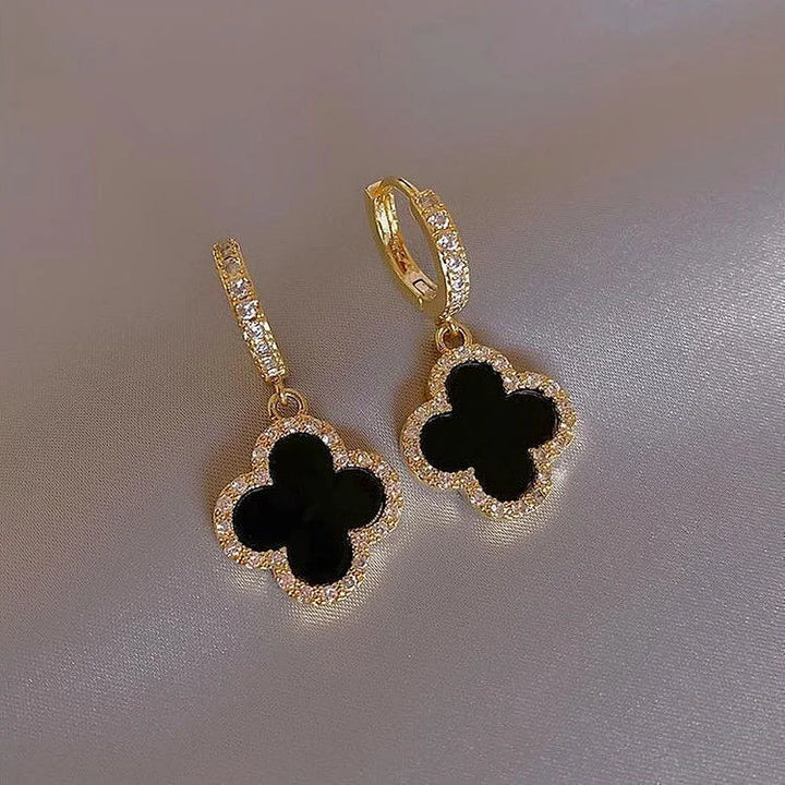 Delicate crystal clover leaf earrings in gold plating, an elegant and lucky jewelry piece for women.