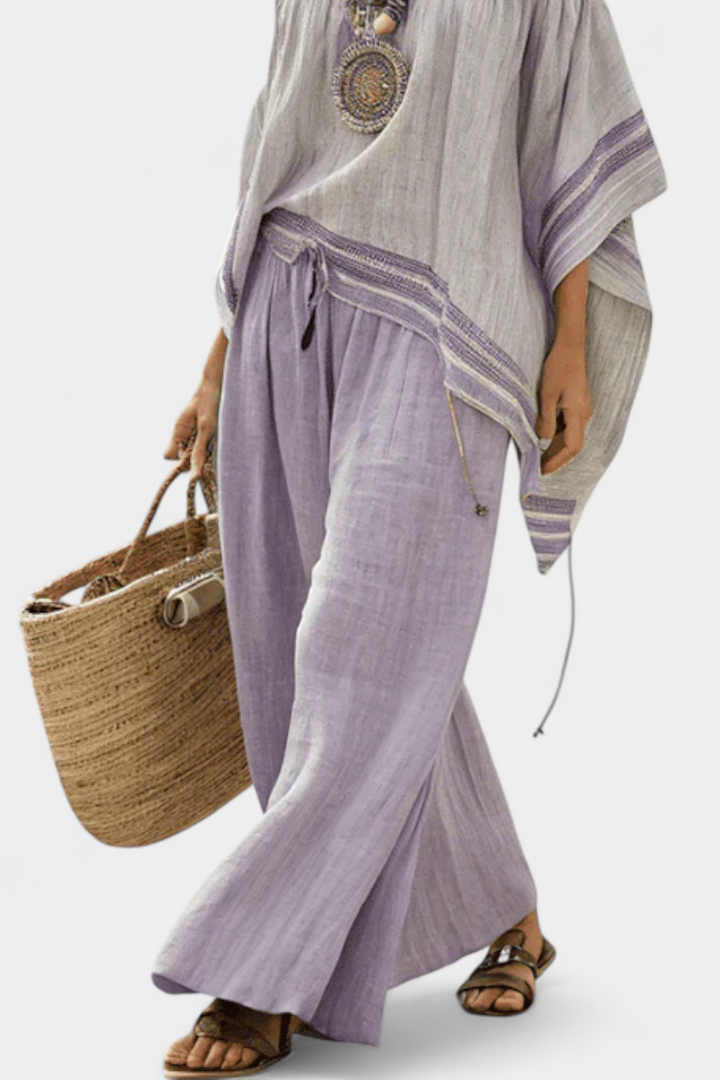 Purple women's two-piece set featuring an off-shoulder top and comfortable striped wide-leg pants for elegant casual style.