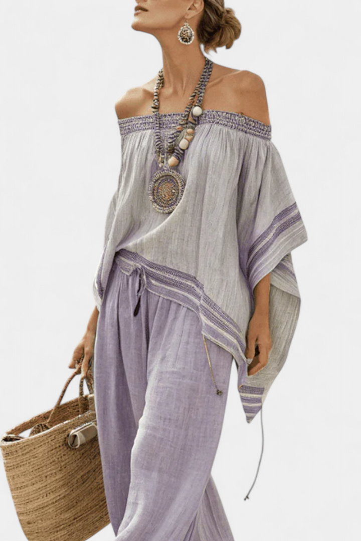 Stylish women's purple off-shoulder top with striped wide-leg pants. Elegant two-piece set, ideal for holiday fashion.