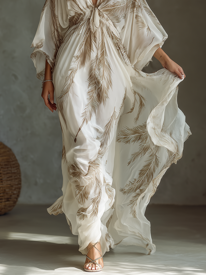Flowy elegant maxi dress for women, with vibrant palm leaf print, V-neck, and stylish twisted front. Great for formal wear.