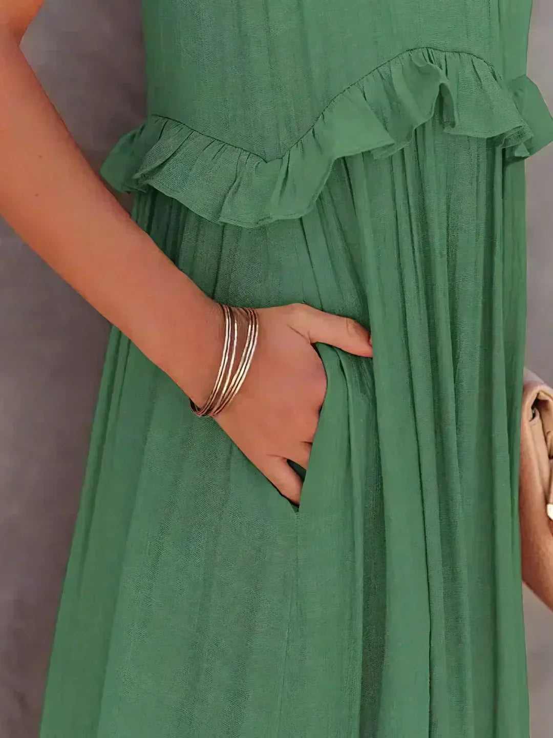 Flowy yellow halterneck maxi dress, ruffles & pockets, great for casual summer elegance.