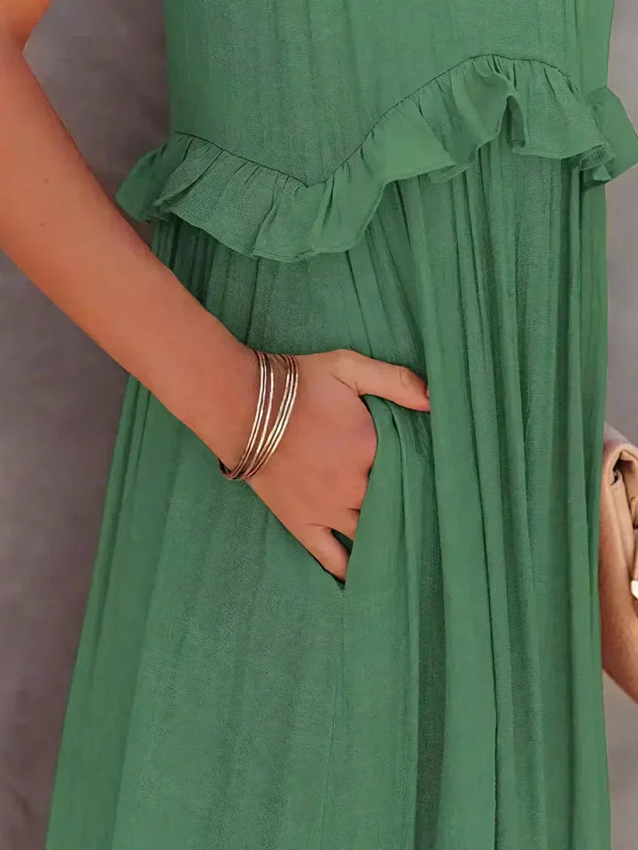 Flowy yellow halterneck maxi dress, ruffles & pockets, great for casual summer elegance.