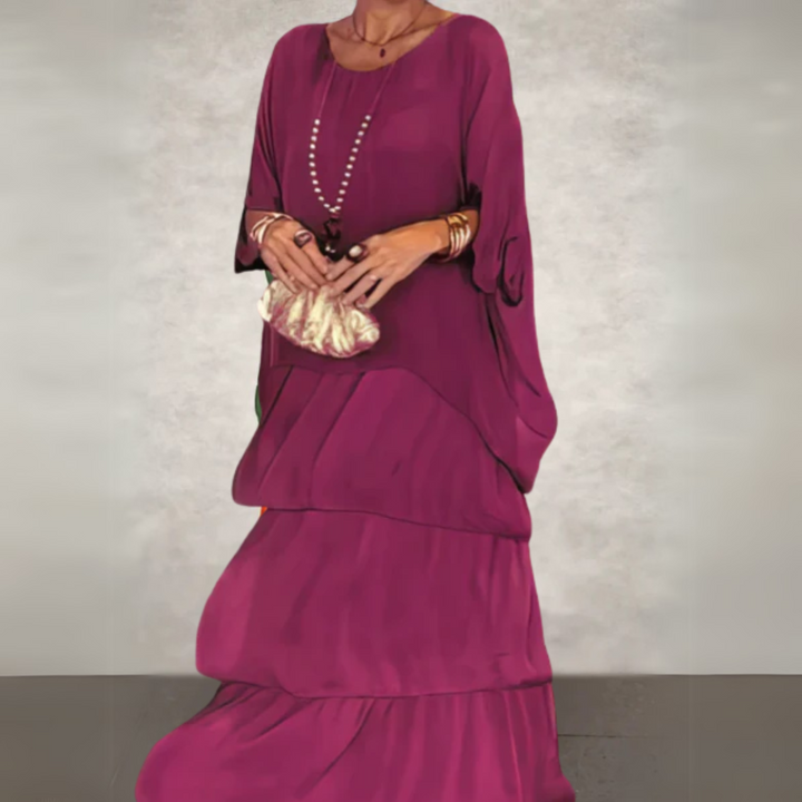 Plus size elegant tiered maxi dress with long sleeves, offering a relaxed fit and flowy silhouette for women.