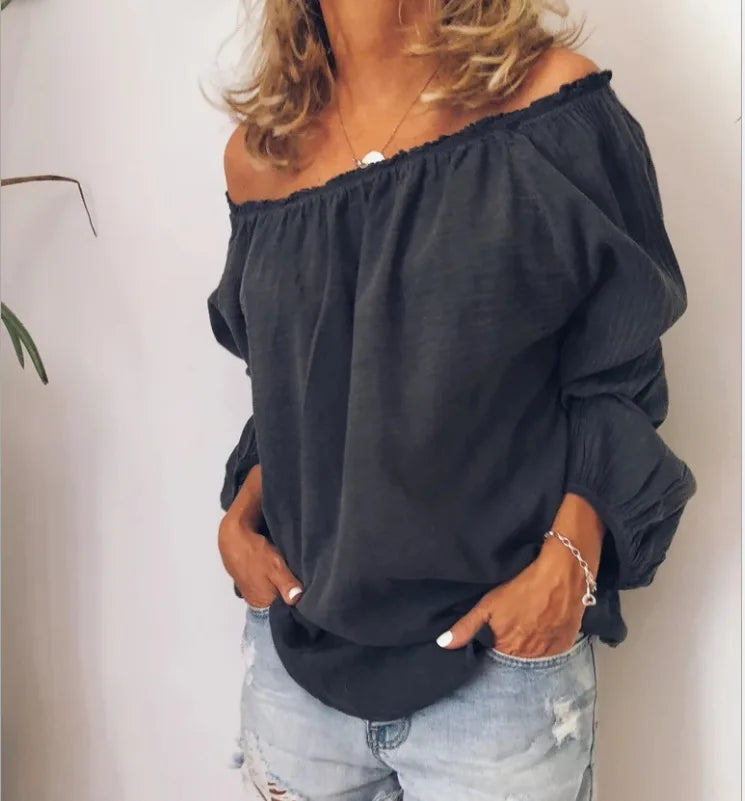 Stylish women's off-shoulder blouse featuring elegant, voluminous balloon sleeves for spring fashion.