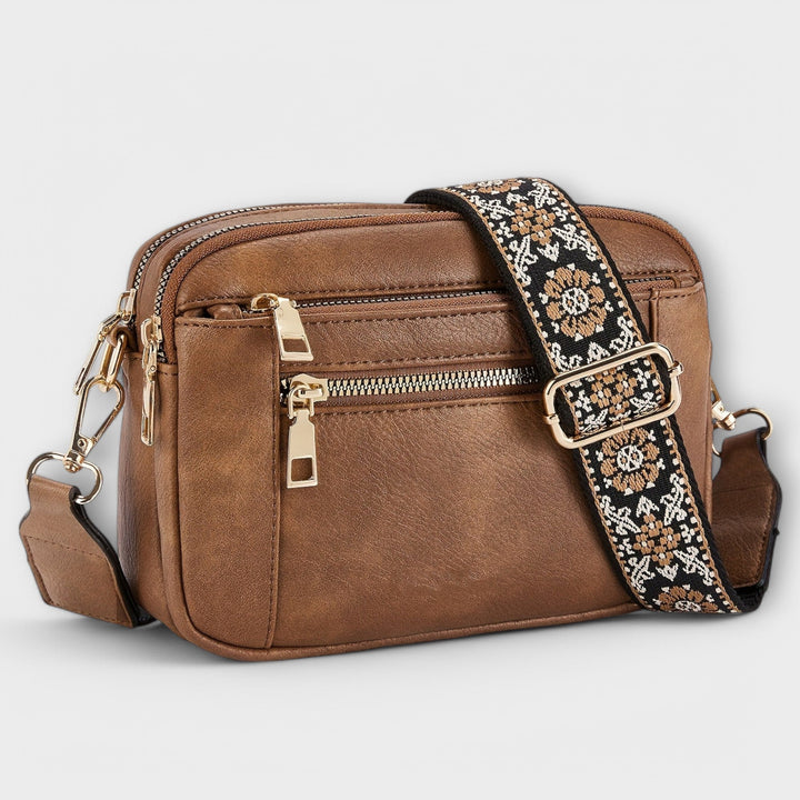 Retro women's vegan leather crossbody bag with a vibrant boho strap; stylish & adjustable.