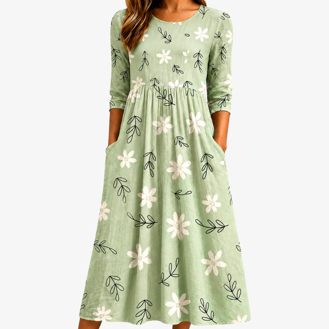 Women's sage green floral midi dress with botanical print & pockets, ideal for casual everyday spring/summer comfort.