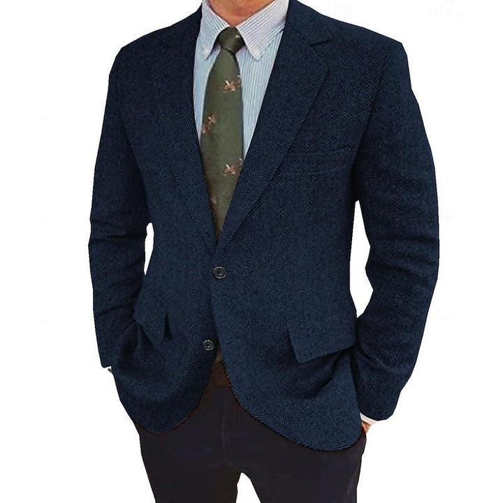Model wearing a classic grey men's two-button tailored jacket, styled for a smart casual outfit.