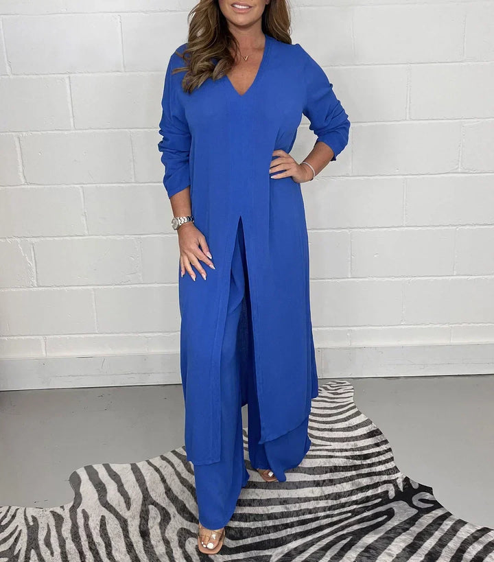Casual women's long sleeve V-neck slit top & relaxed fit pants set. Modern two-piece autumn fashion.