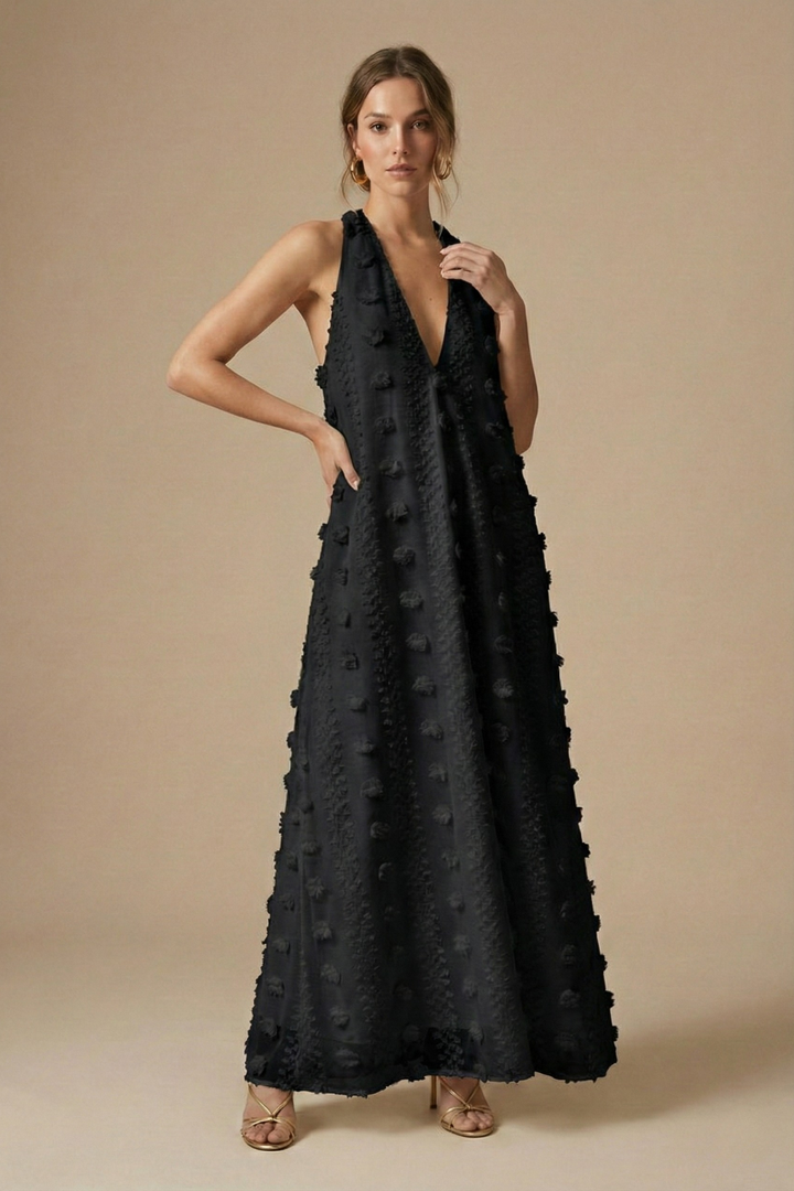 Luxurious women's backless halter maxi dress, adorned with detailed 3D floral appliqué for a captivating evening look.