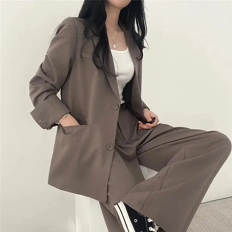 Elegant women's professional wear, a stylish tailored blazer and trouser ensemble.