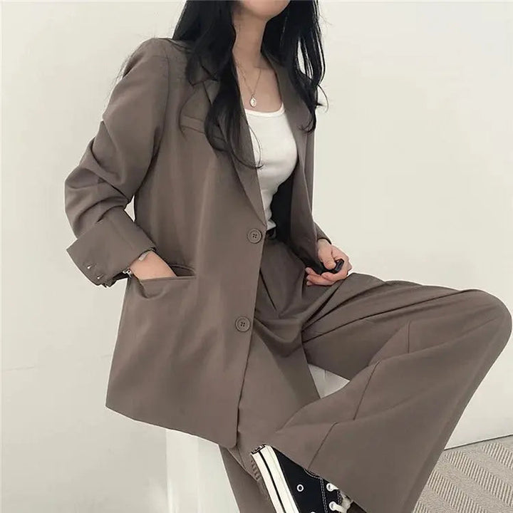 Elegant women's professional wear, a stylish tailored blazer and trouser ensemble.