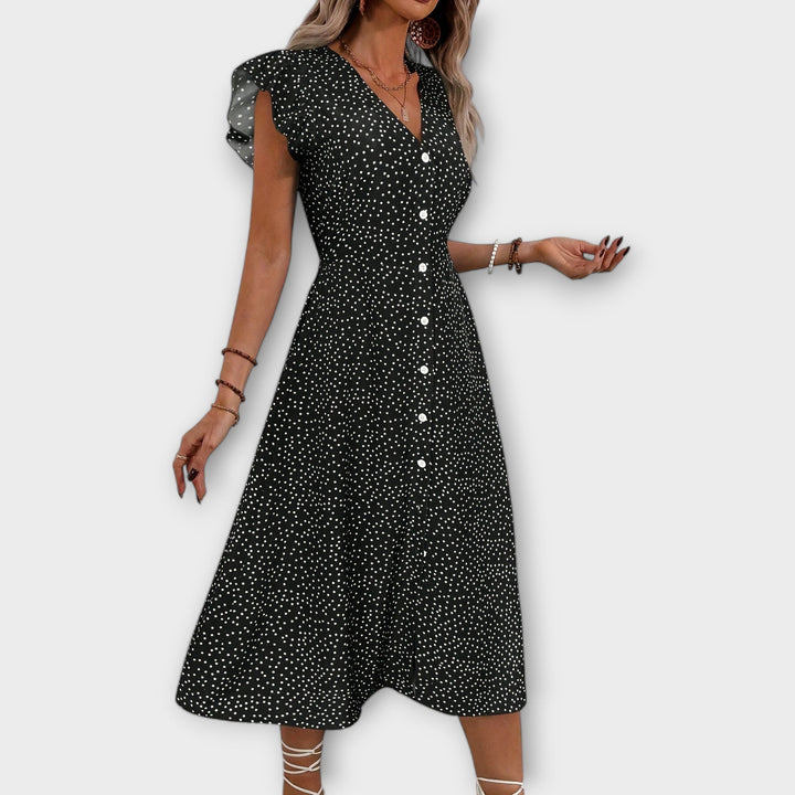 Comfortable women's A-line dress in a stylish polka dot print, suitable for elegant spring occasions.