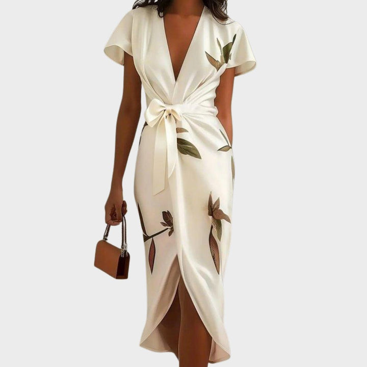 Chic leaf print wrap dress, ideal for garden parties or as a wedding guest outfit. Features an elegant V-neck.