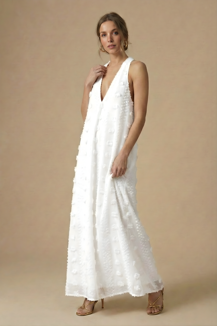 Flowing women's maxi dress with a stylish halter neckline, backless design, and intricate 3D floral embellishments.