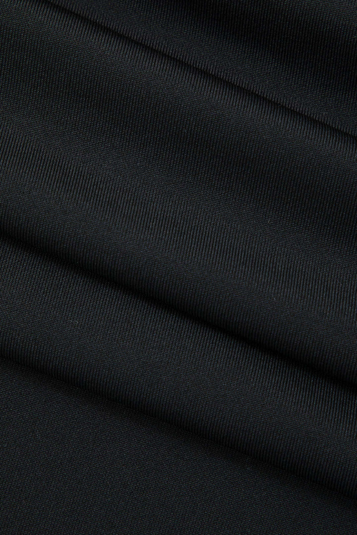 Modern strapless bodycon midi dress, featuring a unique fringe hem, perfect for cocktails.