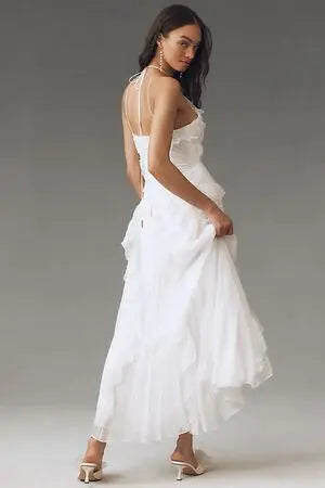 Woman twirling in a charming flowy ruffle dress, an elegant sleeveless women's versatile dress.