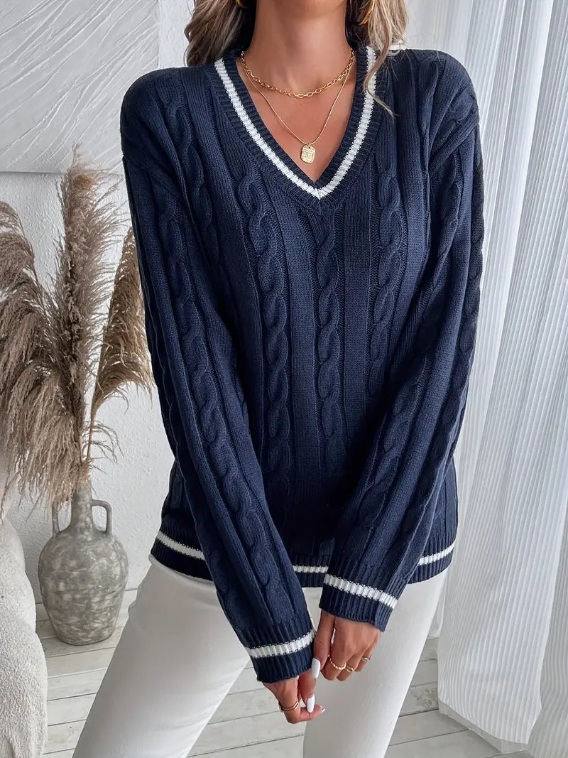 Cozy women's cable knit V-neck sweater, navy blue with chic striped trim. Ideal for autumn & winter style.