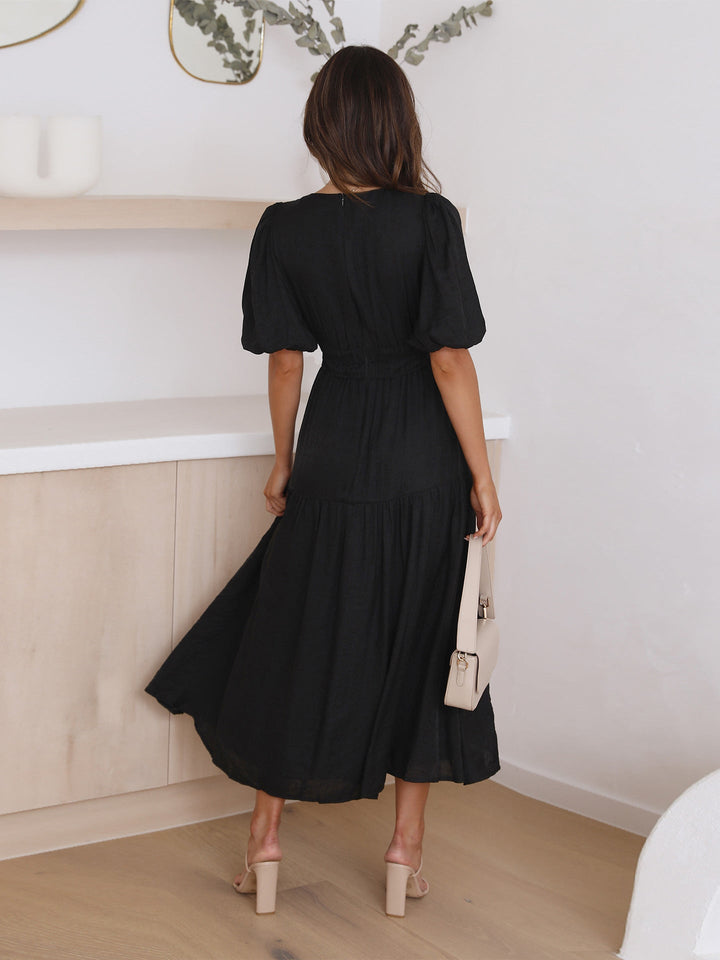 Flowing design of a women's elegant V-neck smocked midi cocktail dress, ideal for summer events.