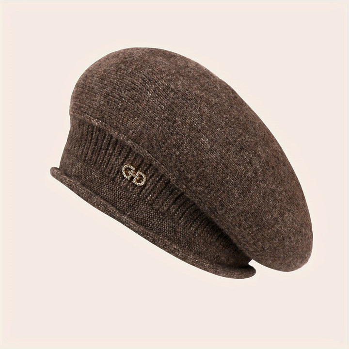 Fashion-forward women's beret. Elegant knitted hat, offering chic warmth for winter outfits.