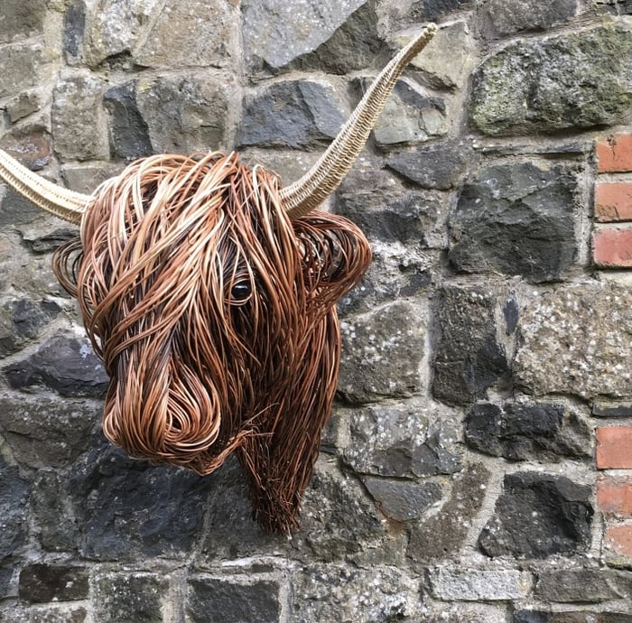 Handmade rattan Toro wall art, animal-inspired rustic statement piece for living room.
