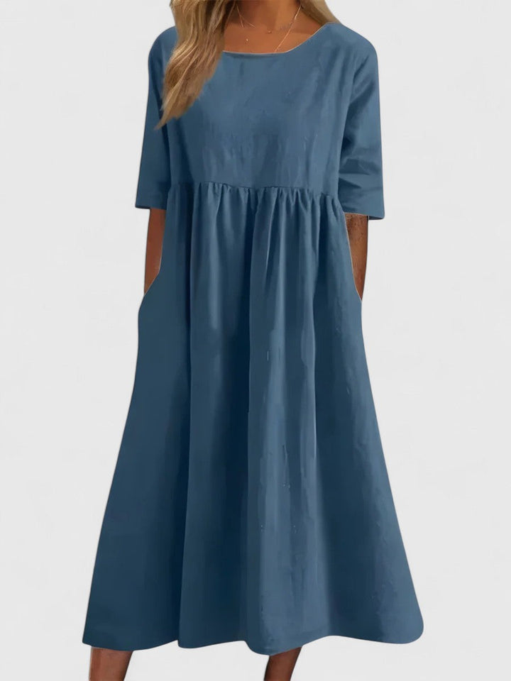 Elegant women's lightweight summer midi dress with round neck and pockets for comfortable everyday wear.