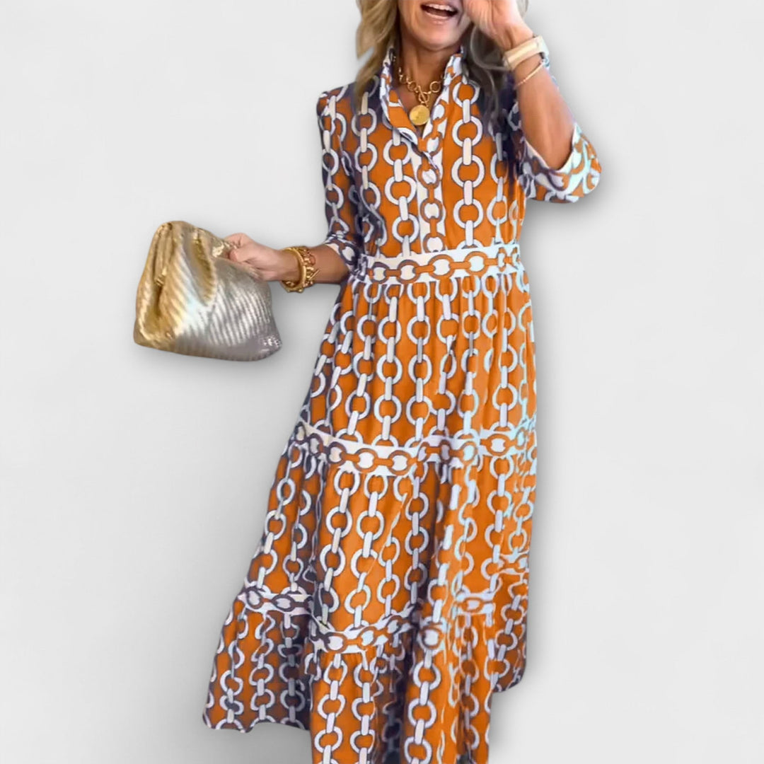 Stylish women's midi dress with a unique chain print. Features a smart collar and three-quarter sleeves.
