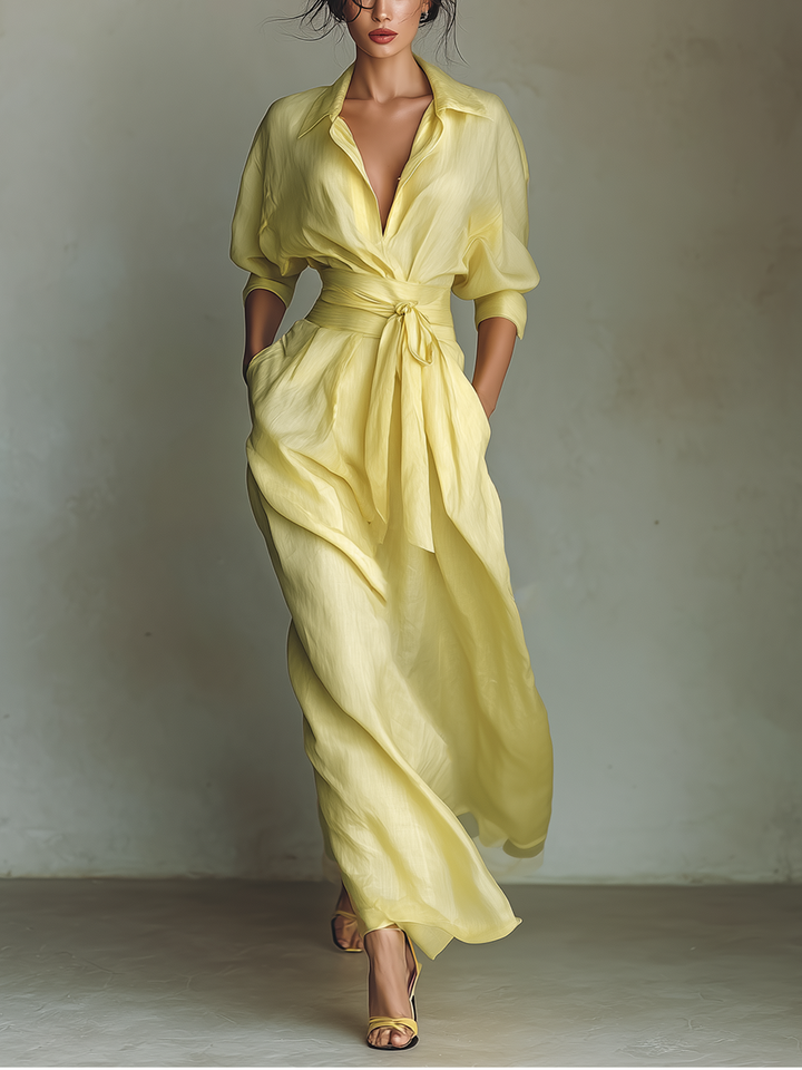 Elegant yellow women's maxi shirt dress with a stylish tie belt, V-neck, and three-quarter sleeves for events.