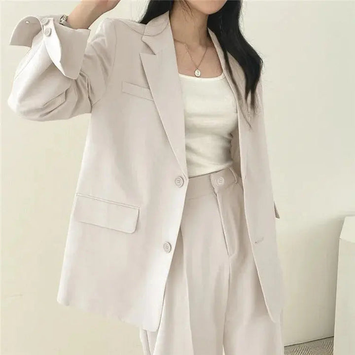 Women's elegant tailored blazer, part of a chic two-piece business suit.