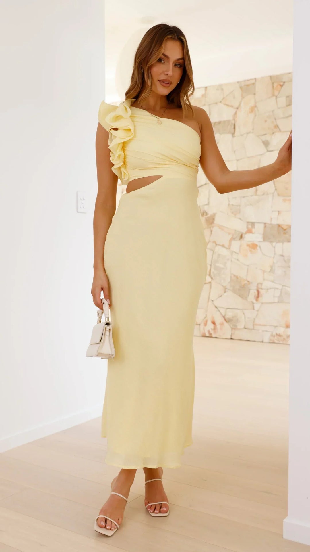 Women's formal yellow one-shoulder maxi dress with elegant frill detail and stylish cutout.