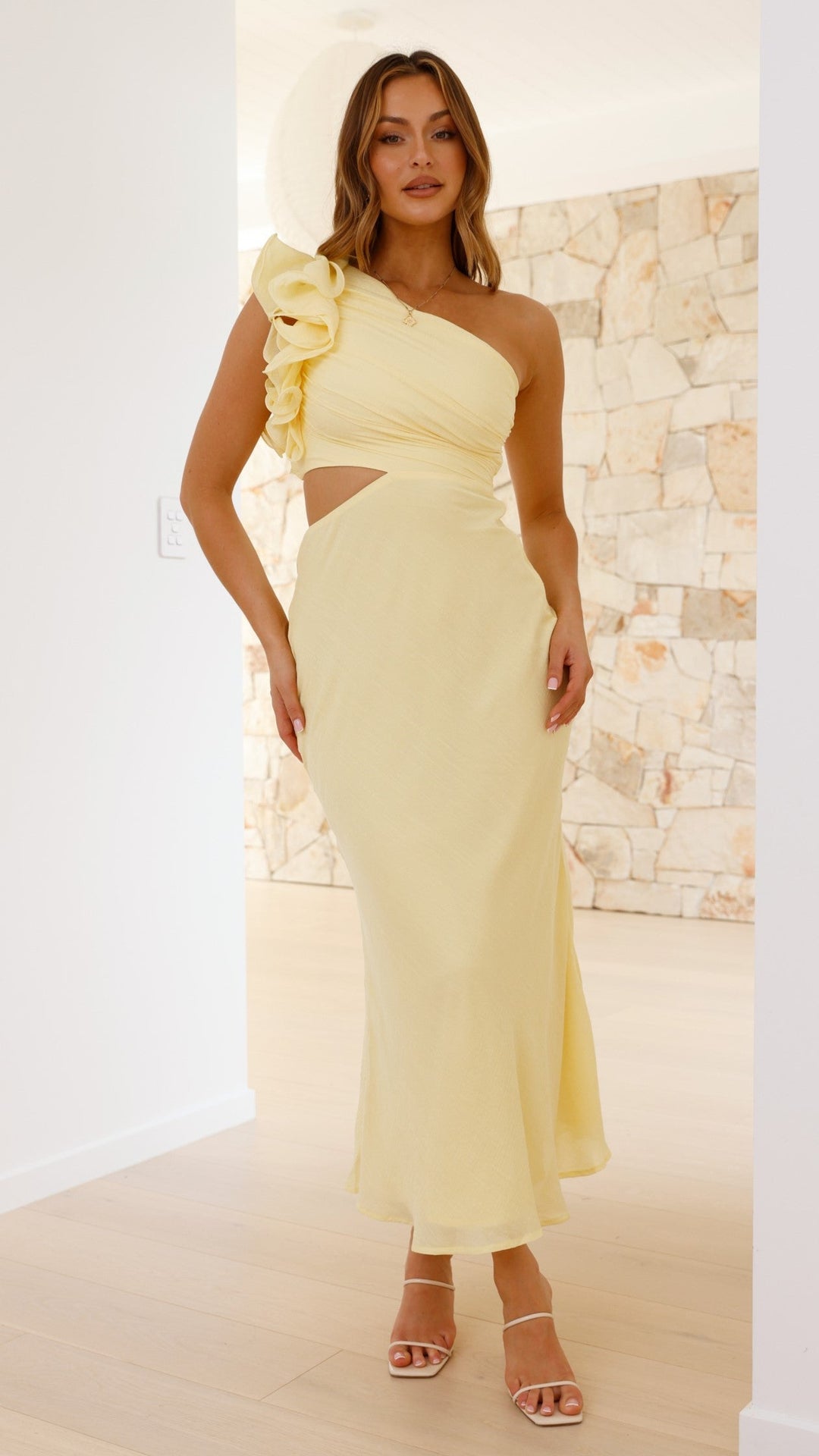 Elegant yellow one-shoulder maxi dress with a chic cutout, perfect for formal evening occasions.