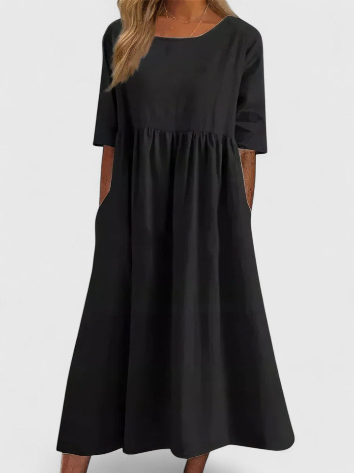 Women's summer midi dress featuring practical pockets, a round neck, lightweight and comfortable for everyday.