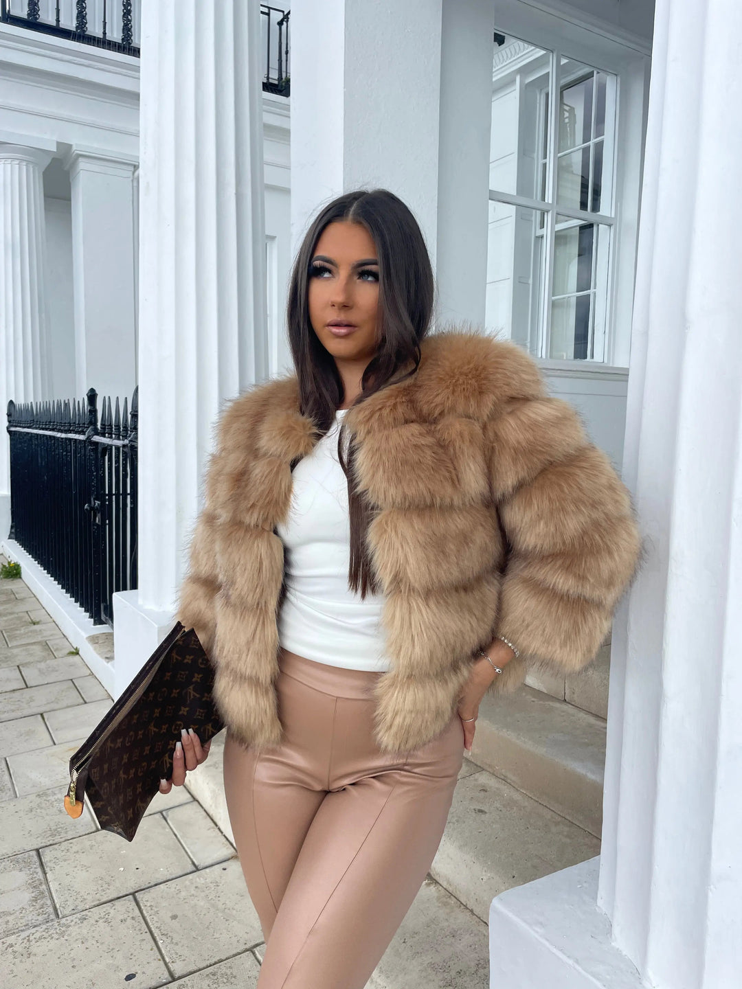 Side view of model in an elegant women's winter coat, chic and cozy for winter fashion.