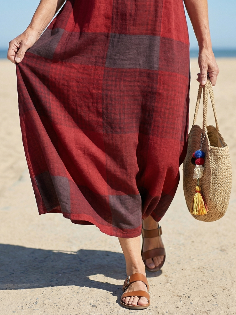 Stylish women's plaid midi dress featuring a relaxed fit, short sleeves, and a chic burgundy pattern.