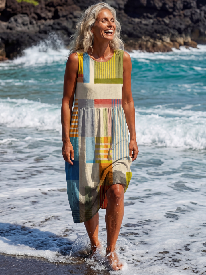 Vibrant patchwork midi dress for women. Multi-color painted block print, sleeveless, relaxed fit for everyday wear.