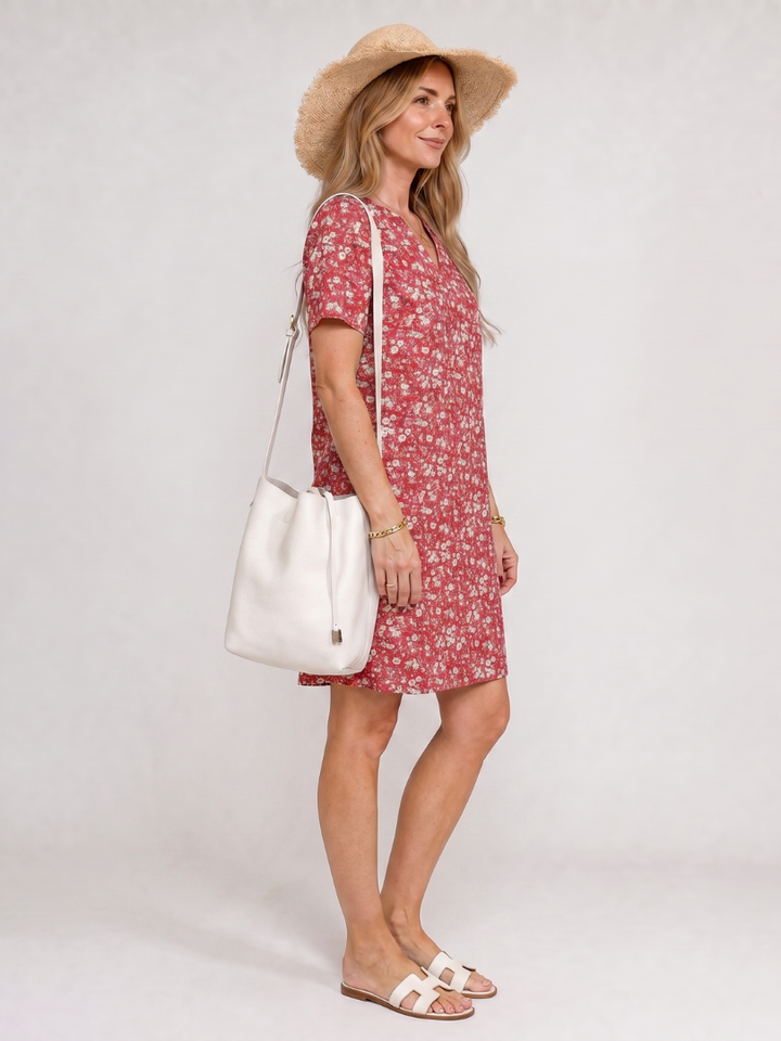 Relaxed fit women's V-neck dress featuring a vibrant geometric print. Short sleeve, knee-length comfort for women's fashion.