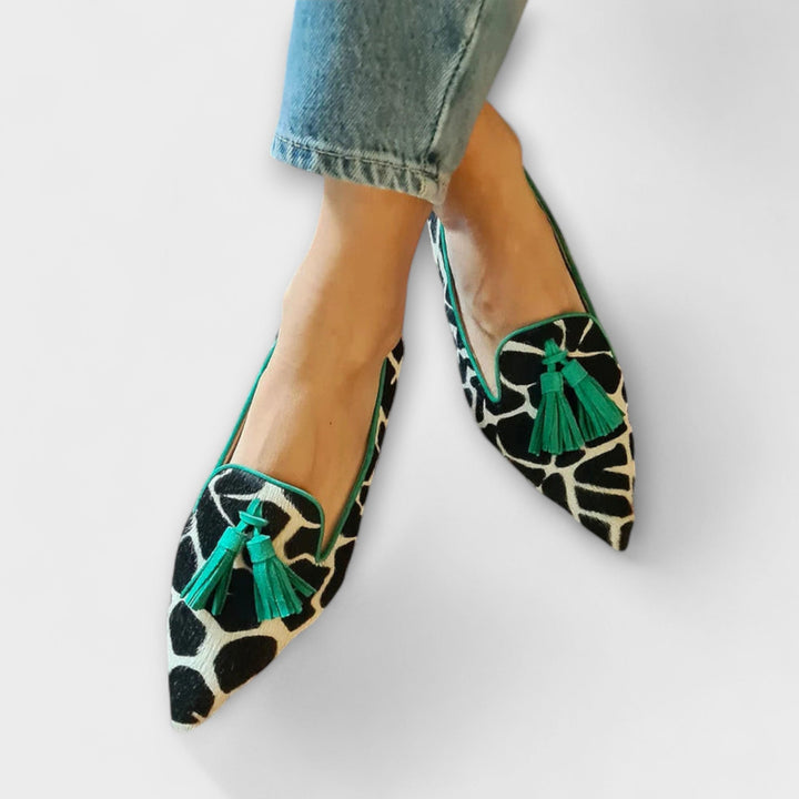 Women's chic slip-on tassel loafers featuring a pointed toe. Stylish & comfortable footwear for any occasion.