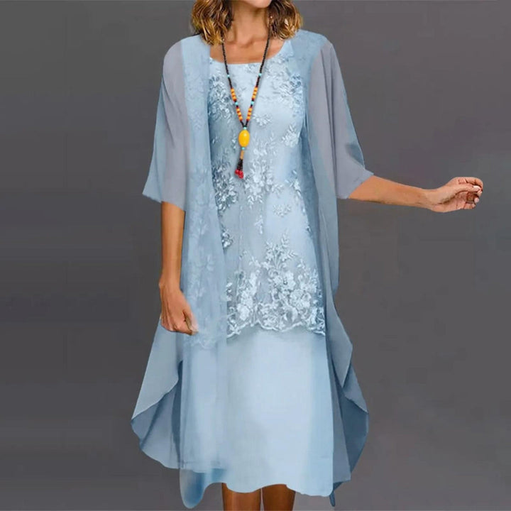 Fashionable women's two-piece dress featuring 3/4 sleeves, round neck, and knee-length design. Versatile style.