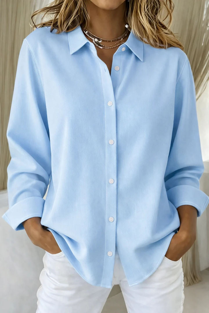 Women's fashionable relaxed fit button down long sleeve shirt, collared, offering a blend of comfort & style.