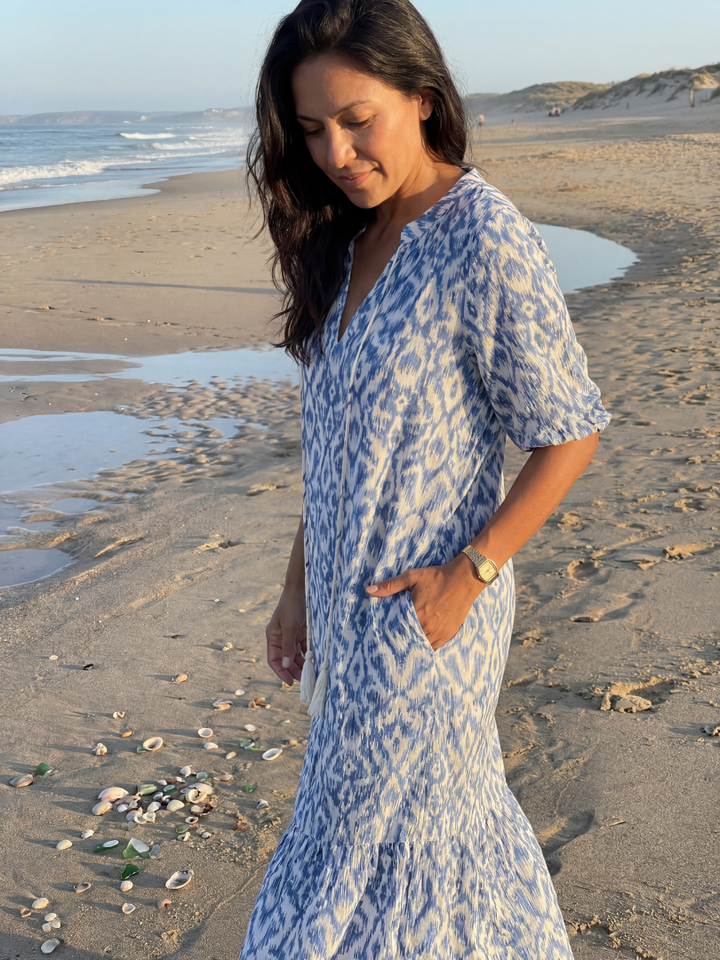 Pull-on women's midi dress, vibrant geometric pattern. Relaxed fit, short sleeve, V-neck. Great for beach & resort wear.