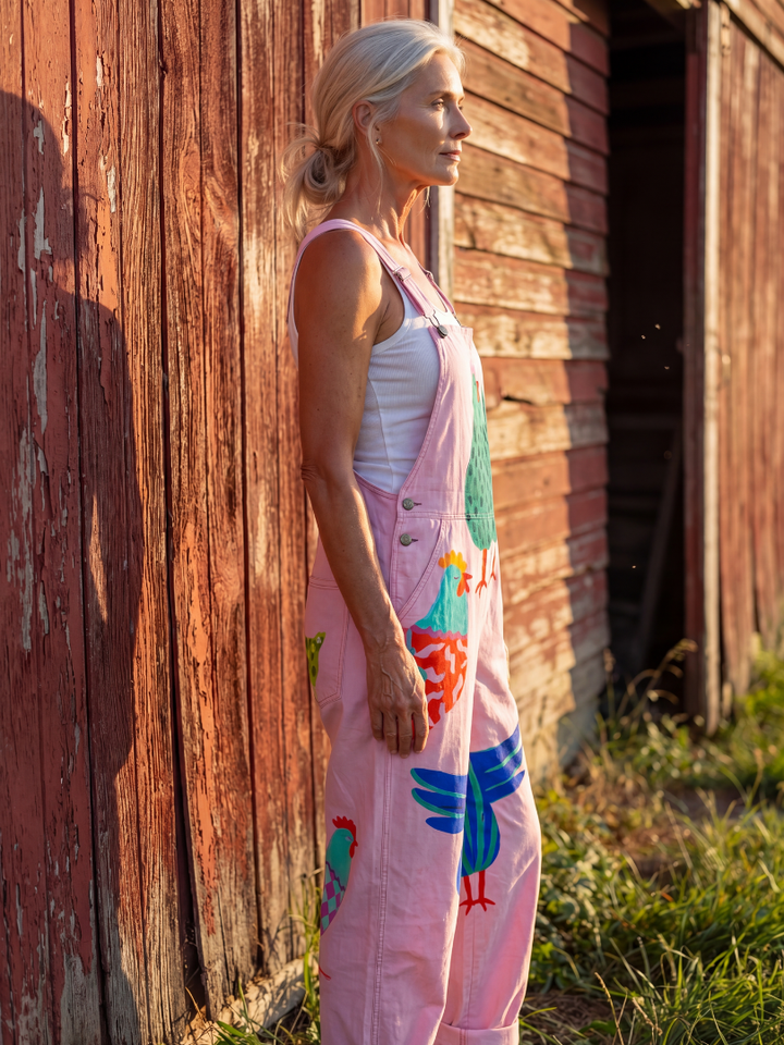 Pink women's relaxed jumpsuit with playful hen motif animal print. Ideal for casual wear, off-duty or summer outfits.