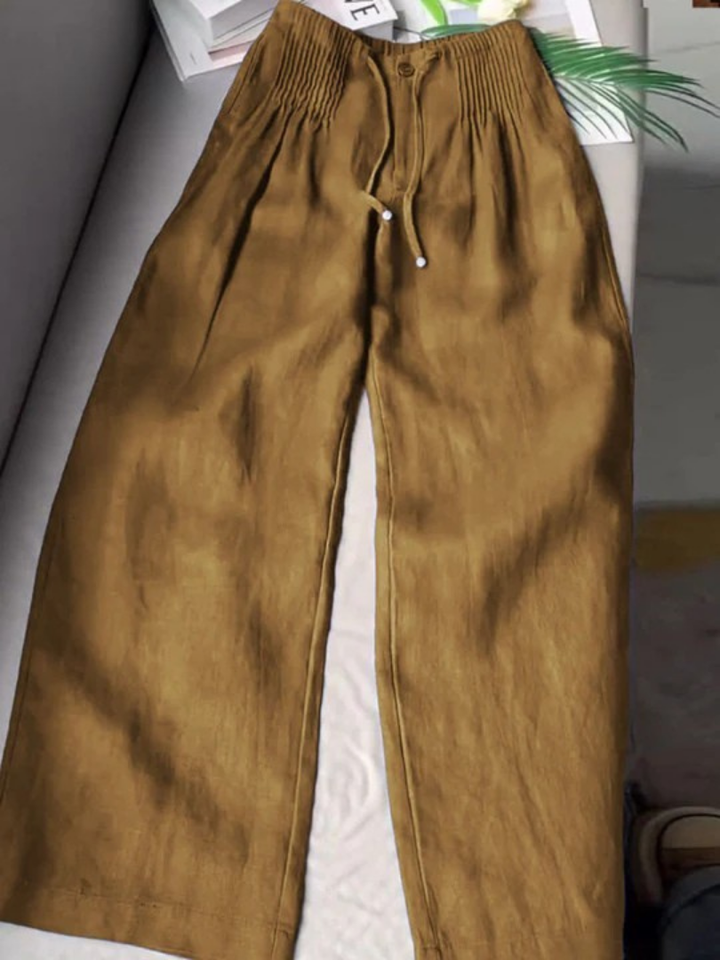 Stylish women's wide leg trousers featuring an elastic waist and straight hem for comfortable wear.
