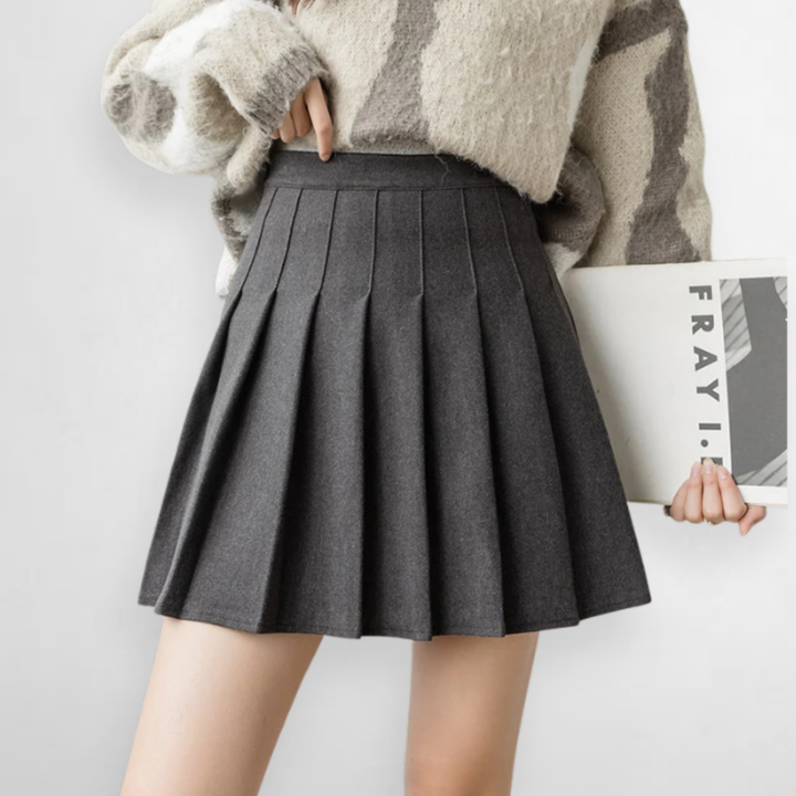 Women's high waist pleated mini skirt, A-line cut, emphasizing elegant pleats. Versatile for fashion outfits.