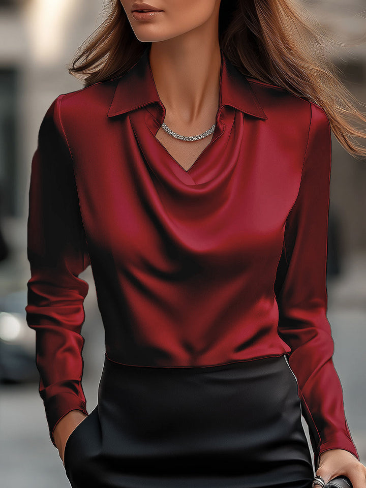 Refined women's formal blouse, featuring an elegant draped neck and smooth satin fabric.